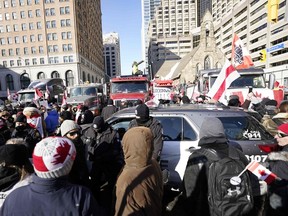 Demonstrators against mandates related to COVID-19 vaccines and restrictions gather in downtown Toronto, on Saturday, Feb. 5, 2022.