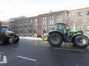 Toronto Police shut down intersections in and around Queen's Park Circle and on "hospital row" on University Ave. in preparation for Saturday's trucker rally. Large farm machinery and pickup trucks tried to gain access to Queen's Park but were cut off and turned around at College and McCaul St. around 1:30 p.m. on Friday, Feb. 4, 2022.