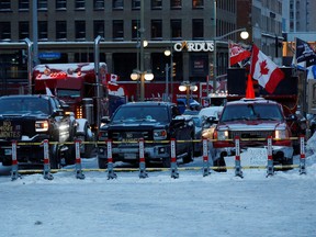 Police barricades are seen as truckers and supporters continue to protest COVID-19) vaccine mandates in Ottawa on Friday, Feb. 4, 2022.