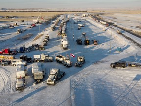 A truck convoy of anti-COVID-19 vaccine mandate demonstrators continue to block the highway at the busy U.S. border crossing in Coutts, Alta., Feb. 2, 2022.