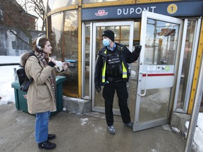 A TTC security officer directs a transit rider from Dupont Station becuase it is closed for an investigation on Wednesday, Feb. 9, 2022.
