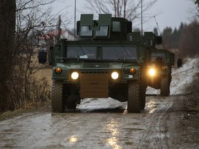 U.S. Army soldiers from the 82nd Airborne Division, deployed to Poland to reassure NATO allies, drive HMMWV (Humvee) vehicles towards an airbase, near Arlamow Poland, February 23, 2022