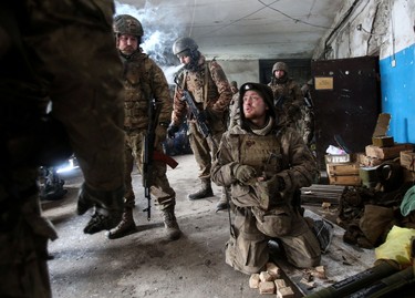 Servicemen of the Ukrainian Military Forces prepare their equipment to repel a tank attack on a position in the Lugansk region, Saturday, March 5, 2022.
