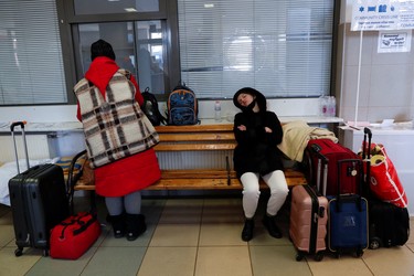People fleeing Russia's invasion of Ukraine rest at the train station in Zahony, Hungary, Sunday, March 6, 2022.