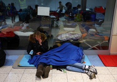 People take rest inside a temporary accommodation and transportation hub for refugees at a former shopping mall, after fleeing the Russian invasion of Ukraine, in Przemysl, Poland, Sunday, March 6, 2022.