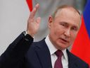 Russian President Vladimir Putin speaks during a news conference following talks with Hungarian Prime Minister Viktor Orban in Moscow, Feb. 1, 2022. 