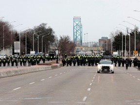 Police gather to clear protestors who blocked the entrance to the Ambassador Bridge in Windsor on February 13, 2022.