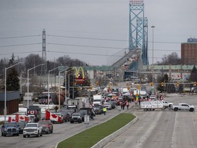 Protesters set up at a blockade at the foot of the Ambassador Bridge, sealing off the flow of commercial traffic over the bridge into Canada from Detroit, in Windsor on Thursday, Feb. 10, 2022.