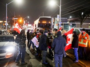 Protesters block the last entrance to the Ambassador Bridge, which connects Detroit and Windsor, effectively shutting it down as truckers and their supporters continue to protest against COVID-19 vaccine mandates, in Windsor, Ont., Wednesday, Feb. 9, 2022.