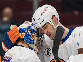 New York Islanders defenceman Zdeno Chara (33) and goalie Ilya Sorokin (30) celebrate their victory against the Vancouver Canucks at Rogers Arena.