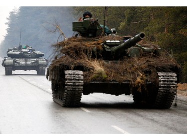 Ukrainian tanks move on a road before an attack in Lugansk region on Feb. 26, 2022.