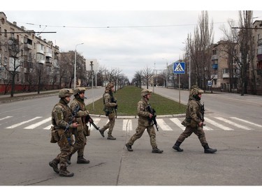 Servicemen of Ukrainian Military Forces walk in the small town of Severodonetsk, Donetsk Region on Feb. 27, 2022.