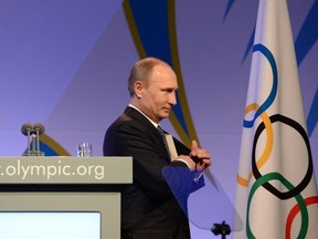 Russian President Vladimir Putin leaves the stage after his speech at the International Olympic Committee (IOC) Gala Dinner on February 6, 2014 in Sochi, on the eve of the Sochi 2014 Olympic Winter Games opening ceremony. -