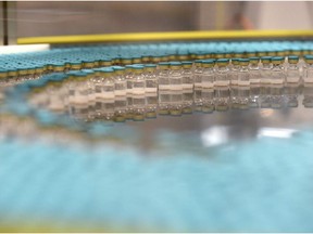 View of vials on a production line at the factory of British multinational pharmaceutical company GlaxoSmithKline (GSK) in Saint-Amand-les-Eaux, northern France, on December 3, 2020, where the adjuvant for Covid-19 vaccines will be manufactured.