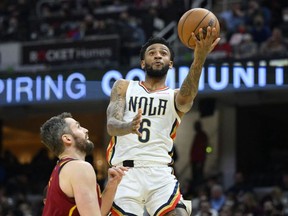 New Orleans Pelicans guard Nickeil Alexander-Walker drives beside Cleveland Cavaliers forward Kevin Love in the third quarter at Rocket Mortgage FieldHouse.