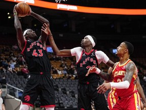 Toronto Raptors forward Pascal Siakam comes down with a rebound as forward Chris Boucher and Atlanta Hawks forward Kevin Knox II look on during the first half at Scotiabank Arena.