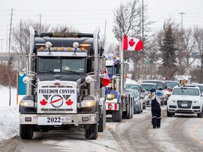 People gather to support truck drivers on their way to Ottawa in protest of coronavirus disease (COVID-19) vaccine mandates for cross-border truck drivers, in Toronto, Ontario, Canada, January 27, 2022.