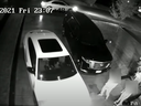 A screengrab from home surveillance video released by Toronto Police shows carjackers backing out of a driveway as two victims look on with a stolen vehicle.