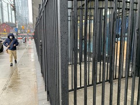 An iron security fence recently erected around a Toronto Community Housing building at 310 Dundas Ave.  E. -- located at the troubled intersection of Dundas and Sherbourne Sts.  -- is seen here on Friday, Feb.  18, 2022.
