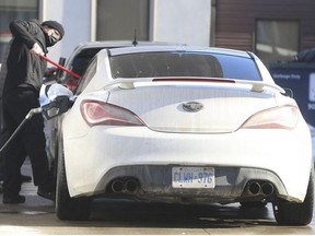 A motorist puts gas in his car in Toronto on Feb. 6, 2022.