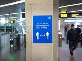 A sign encourages people using public transportation to maintain social distance as the spread of coronavirus disease (COVID-19) continues in Stockholm, Sweden November 4, 2020.