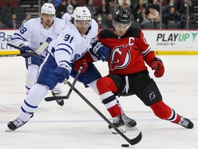 Toronto Maple Leafs center John Tavares and New Jersey Devils center Nico Hischier battle for the puck during the first period at Prudential Center.