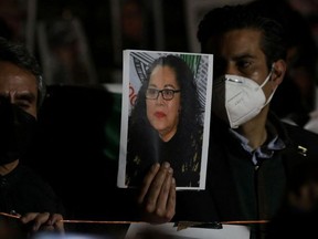 A person holds a picture of Mexican journalist Lourdes Maldonado who was killed in the northern border city of Tijuana, as people attend a vigil to protest against the killing of journalists in past days, outside the Secretariat of the Interior in Mexico City, Mexico, January 25, 2022.