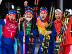 Norway's Ingvild Flugstad Oestberg, Norway's Astrid Uhrenholdt Jacobsen, Norway's Ragnhild Haga and Norway's Marit Bjorgen celebrate after winning the women's 4x5km classic free style cross country relay at the 2018 Winter Olympics.