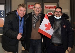 Toronto Sun columnist Joe Warmington, retired Canadian Forces Lt.-Col. Tony White and Ahmad Seyar Sadiqi, aka Radar, after the Afghan interpreter arrived with his family in Ottawa on Thursday, Feb. 11, 2022.