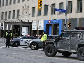 Trucks with Canadian flags and other vehicles are blocked at Church and Bloor Sts. on Saturday, Feb. 12, 2022.
