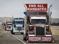 Anti-COVID-19 vaccine mandate demonstrators leave in a truck convoy after blocking the highway at the busy U.S. border crossing in Coutts, Alta., Tuesday, Feb. 15, 2022.