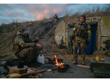 Ukrainian servicemen are seen at fighting positions at the military airbase Vasylkiv in the Kyiv region, Feb. 26, 2022.