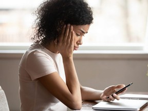 Woman is frustrated to receive text messages from group chat.