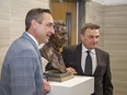 Brent Gretzky (left), and his brother Glen, pose for photos beside a bronze bust of their father Walter Gretzky, that was unveiled on Friday March 4, 2022 outside council chambers at City Hall in Brantford, Ontario. Paris artist Robert Dey was commissioned by Glenhyrst Art Gallery of Brant, who launched a public fundraising campaign to cover the cost of making a bronze bust from Dey's clay sculpture.