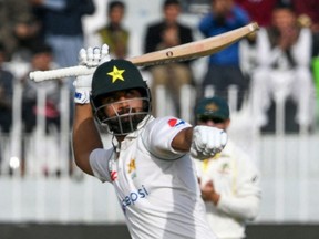Pakistan's Abdullah Shafique celebrates after scoring a century (100 runs) during the fifth day of the first Test cricket match between Pakistan and Australia at the Rawalpindi Cricket Stadium in Rawalpindi on March 8, 2022.