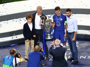 Chelsea's Cesar Azpilicueta celebrates with team owner Roman Abramovich (second from left) after winning the Champions League.