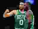 Boston Celtics' Jayson Tatum (left) talks with Jaylen Brown.