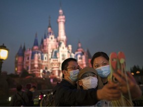 Tourists visit Shanghai Disneyland after its reopening on May 11, 2020 in Shanghai, China. Shanghai Disneyland has reopened its gates following months of shutdown, offering a potential model for other mass entertainment venues around the world to open for business during the pandemic.