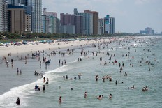 People wade in the ocean on July 4, 2020 in Myrtle Beach, South Carolina.