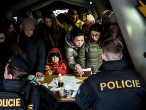 Ukrainian refugees queue to file for residency permits at Prague's foreigner police headquarters on March 2, 2022 in Prague, Czech Republic.