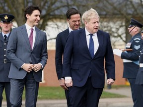 Canadian Prime Minister Justin Trudeau, Dutch Prime Minister Mark Rutte and British Prime Minister Boris Johnson review troops at RAF Northolt, on March 7, 2022 in London, England.