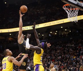 Scottie Barnes #4 of the Toronto Raptors shoots Wenyen Gabriel #35 of the Los Angeles Lakers during the second half of their NBA game at Scotiabank Arena on March 18, 2022 in Toronto, Canada. Photo by Cole Burston/Getty Images