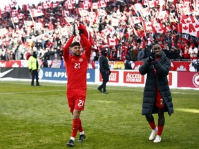 Jonathan Osorio #21 and Richie Laryea #22  of Canada celebrate after the final whistle following a 2022 World Cup Qualifying match against Jamaica at BMO Field on March 27, 2022 in Toronto, Ontario, Canada.