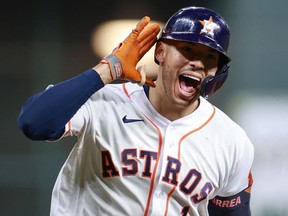 Carlos Correa #1 of the Houston Astros reacts to hitting a solo home run during the seventh inning against the Boston Red Sox during Game One of the American League Championship Series at Minute Maid Park on October 15, 2021 in Houston, Texas.