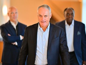 Major League Baseball Commissioner Rob Manfred walks to a press conference during an MLB owner's meeting at the Waldorf Astoria on Feb. 10, 2022 in Orlando.