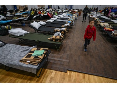 Women and children rest inside the sports hall of a primary school which has been converted to a refugee centre on March 1, 2022 in Przemysl, Poland.