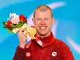 Gold medallist Mark Arendz of Team Canada celebrates during the Men's Para Biathlon Middle Distance Standing medal ceremony at the Zhangjiakou Medals Plaza on day four of the Beijing 2022 Winter Paralympics on March 08, 2022 in Zhangjiakou, China.