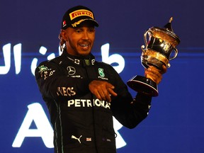 Third placed Lewis Hamilton of Great Britain and Mercedes celebrates on the podium during the F1 Grand Prix of Bahrain at Bahrain International Circuit on March 20, 2022 in Bahrain.