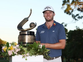 Sam Burns of the United States celebrates with the trophy after winning during a playoff in the final round of the Valspar Championship on the Copperhead Course at Innisbrook Resort and Golf Club on March 20, 2022 in Palm Harbor, Florida.