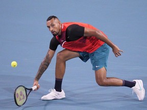 Nick Kyrgios of Australia returns a shot to Adrian Mannarino of France during the 2022 Miami Open presented by Itaú at Hard Rock Stadium on March 23, 2022 in Miami Gardens, Florida.